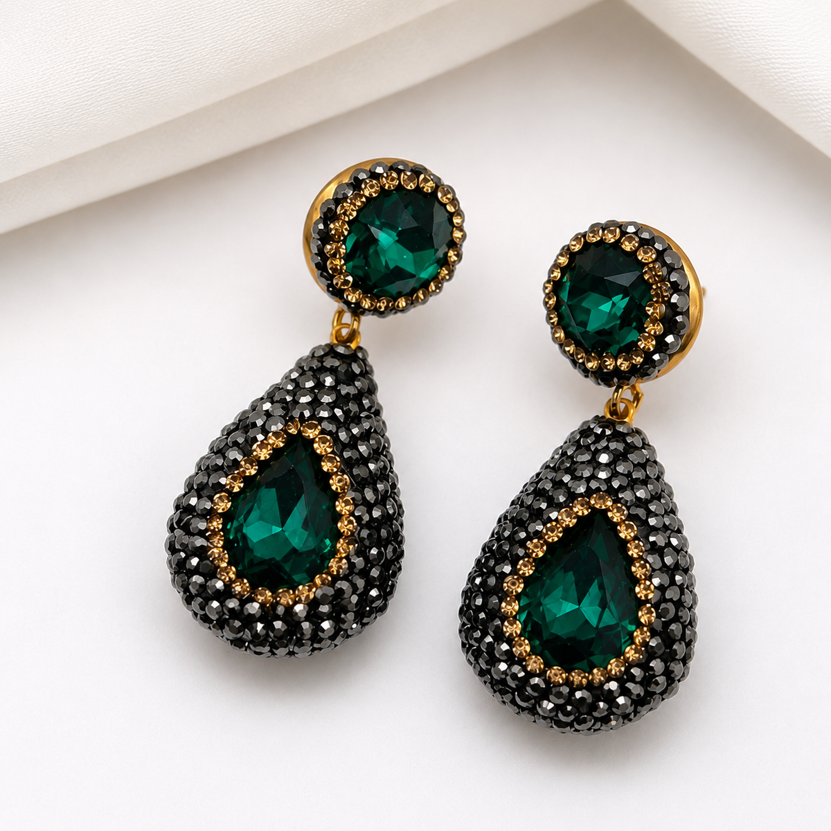 nano stone pendant earrings featuring green gemstones and black pavé rhinestones with gold accents.