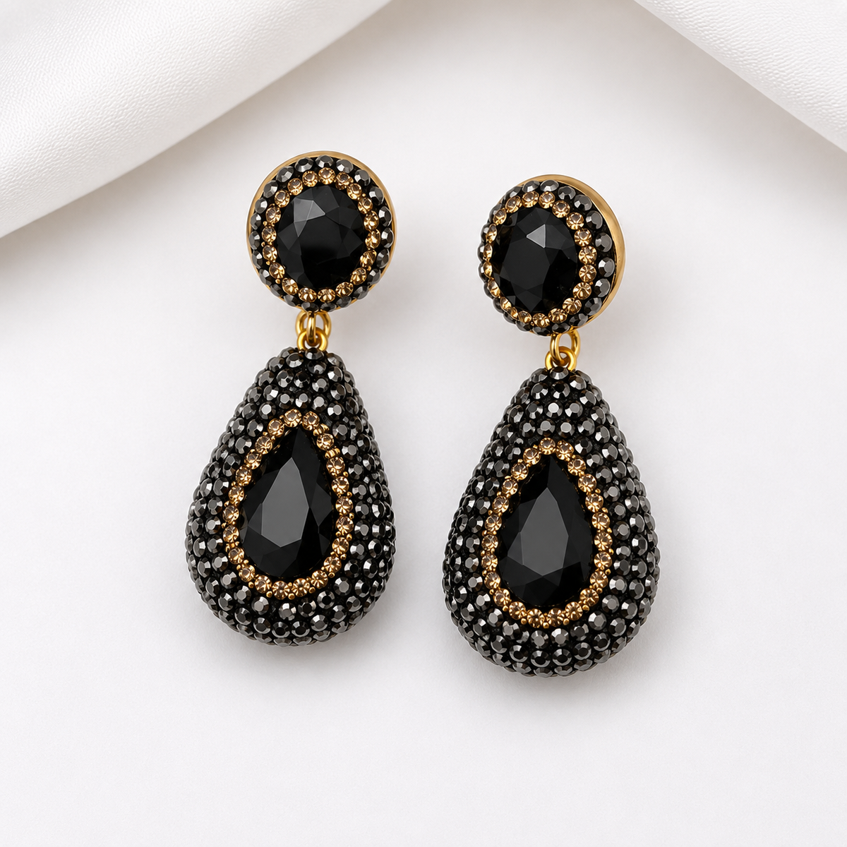 nano stone pendant earrings in black, featuring a teardrop design with pavé rhinestones and gold accents.