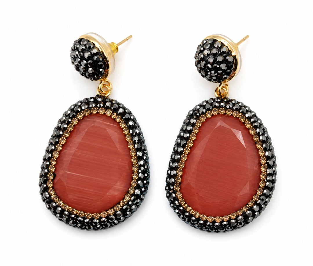 Myra stone pendant earrings featuring a stunning red stone pendant with sparkling rhinestones and gold accents.