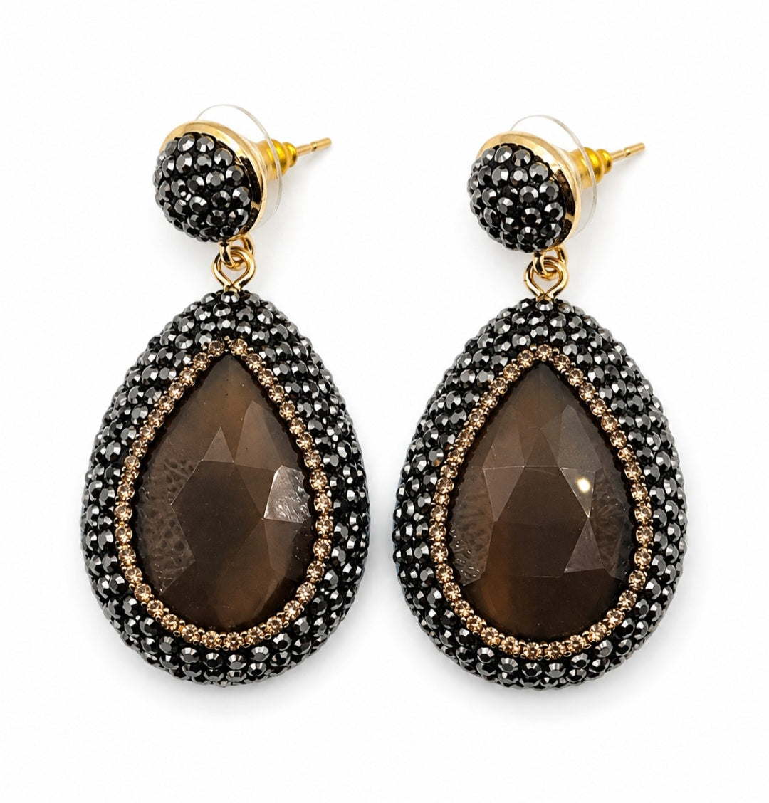 Nisa stone pendant earrings in bronze with rhinestone embellishments, featuring teardrop stone design.