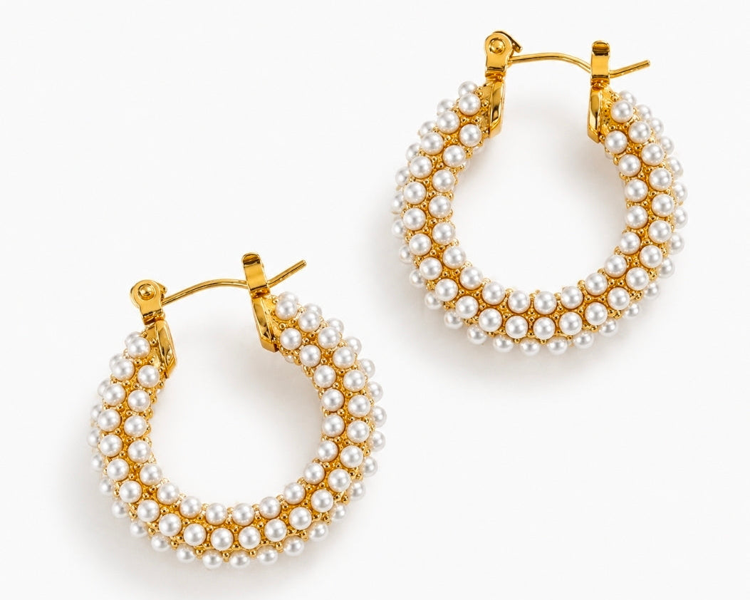 chunky pearl hoop earrings in 18k gold plating with intricate pearl embellishments.