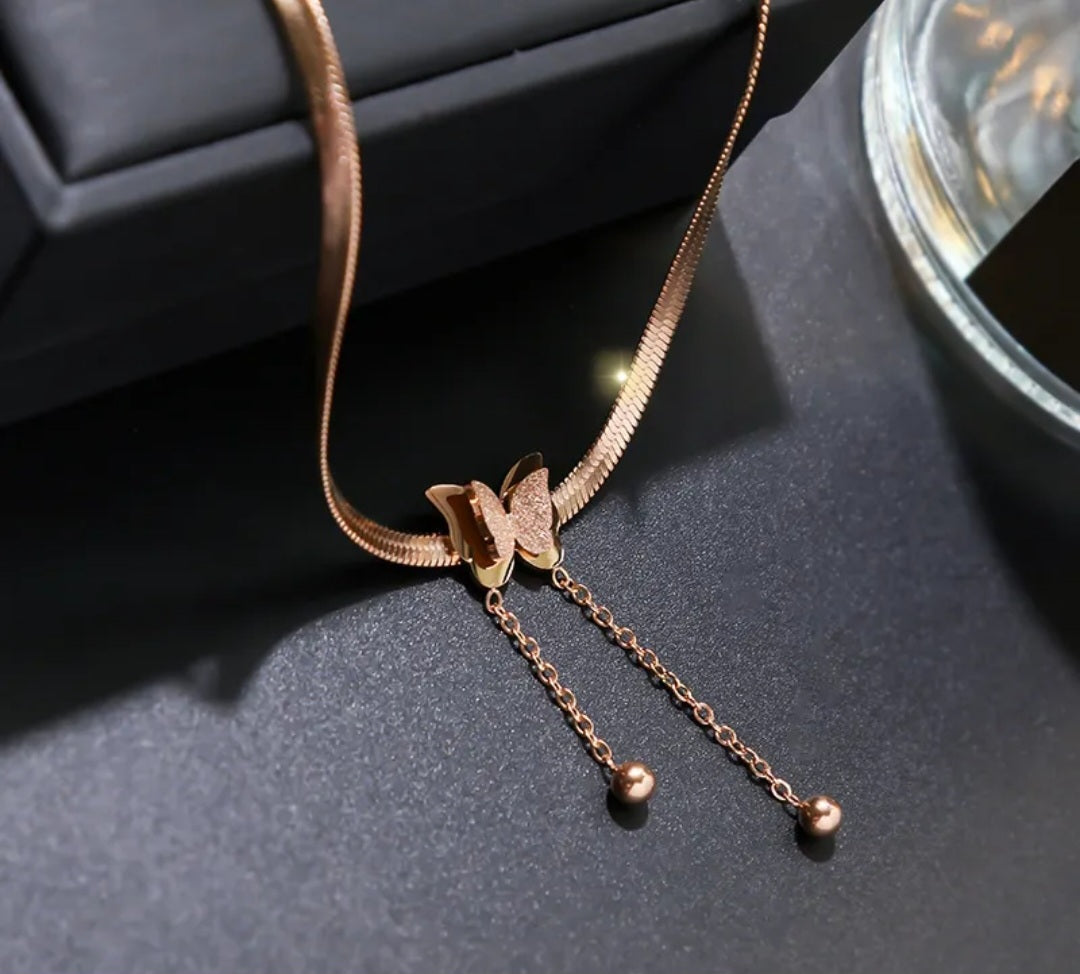 NIDA charm necklace featuring a delicate butterfly pendant on a sleek chain, perfect for elegant styling.