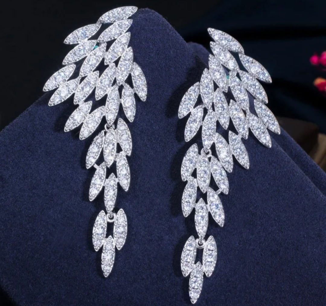 Nysa feather earrings with cascading angel wing drops featuring marquise-cut cubic zirconia leaf petals.