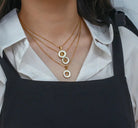 personalized initial necklace featuring K, N, Z pendants in gold plating, worn by a woman
