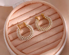 Chunky pearl hoop earrings beautifully displayed in a jewelry box with plush lining and secure closures.