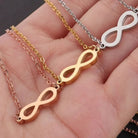 infinity necklace in gold and silver displayed on a hand showcasing gold, silver, and rose gold variations.
