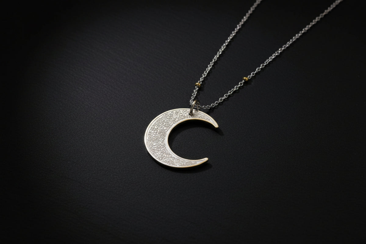 Ayatul Kursi necklace crescent with intricate designs on a silver crescent pendant.