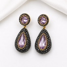 Nano stone pendant earrings in purple with black pavé rhinestones and gold accents, showcasing luxury and elegance.