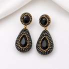 nano stone pendant earrings in black, featuring a teardrop design with pavé rhinestones and gold accents.