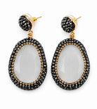 Myra stone pendant earrings featuring a clear stone surrounded by sparkling rhinestones and gold accents.