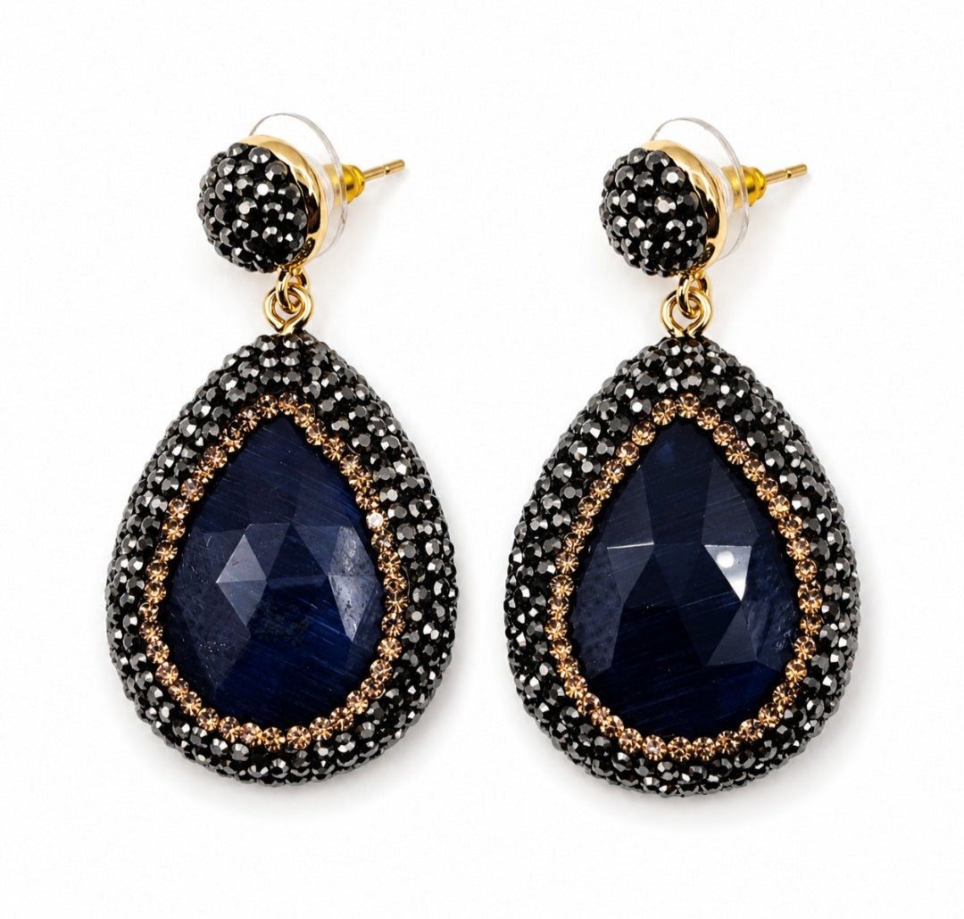 Nisa stone pendant earrings with black rhinestones and gold plating, featuring a teardrop stone design.