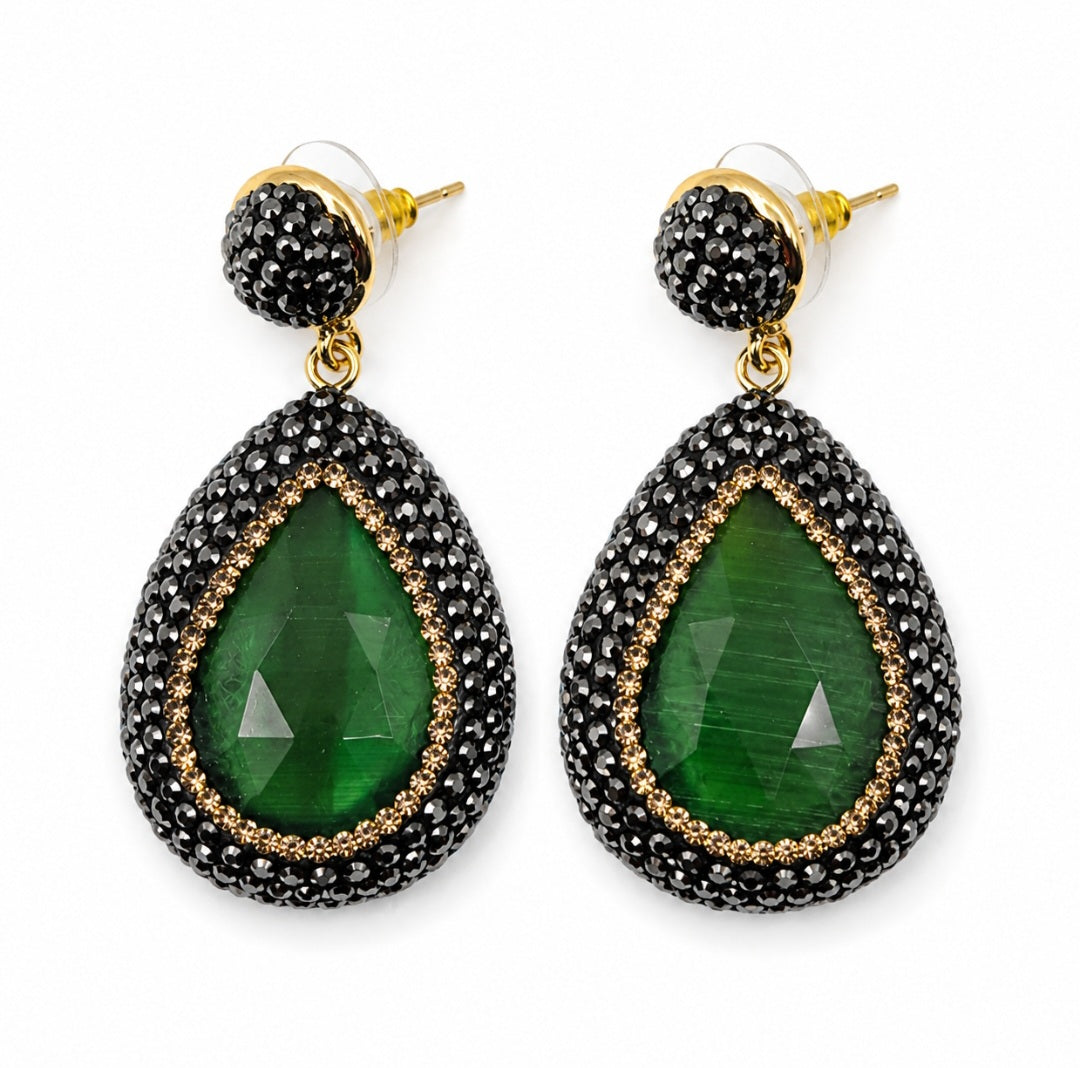 Nisa stone pendant earrings featuring green stone pendants surrounded by rhinestones on a gold plated setting.