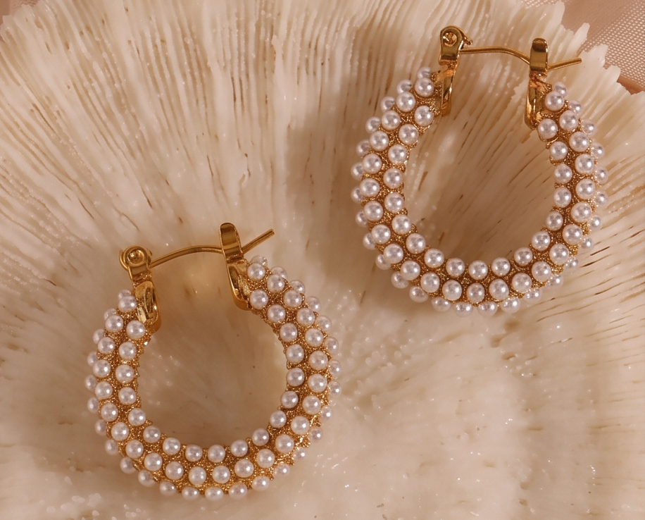 chunky pearl hoop earrings set on 18k gold plating with tiny white pearls, perfect for modern elegance.