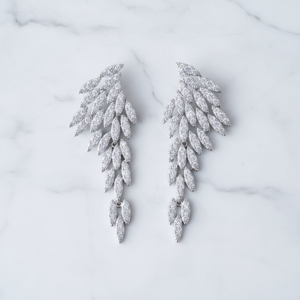 Nysa feather earrings featuring cascading angel wing drops with marquise-cut cubic zirconia crystal leaf petals.