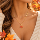 Autumn Glow maple leaf necklace with ruby-red cubic zirconia stones  model
