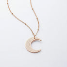 Ayatul Kursi necklace crescent with a shiny crescent pendant on a delicate chain.