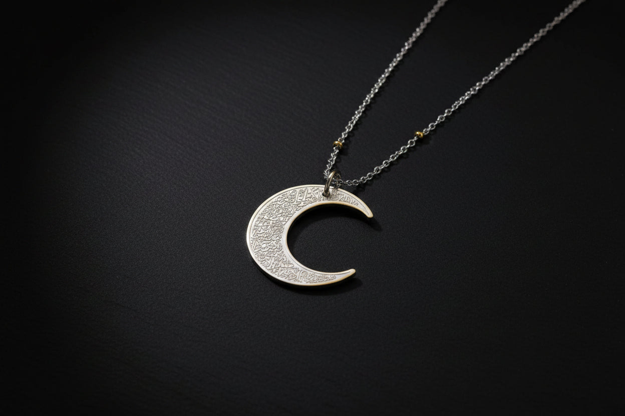 Ayatul Kursi necklace crescent with intricate designs on a silver crescent pendant.