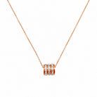 Cubic zirconia pendant necklace with sleek cylindrical design and shimmering stones, featured in the Ariana collection.