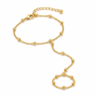 Gold beaded hand chain with finger loop, lobster clasp, and adjustable extension chain 