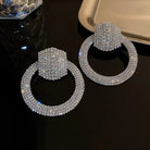 Liya Crystal Pavé Drop Hoop Earrings – Rhinestone Encrusted Hoops in silver | Zoha Los Angeles
