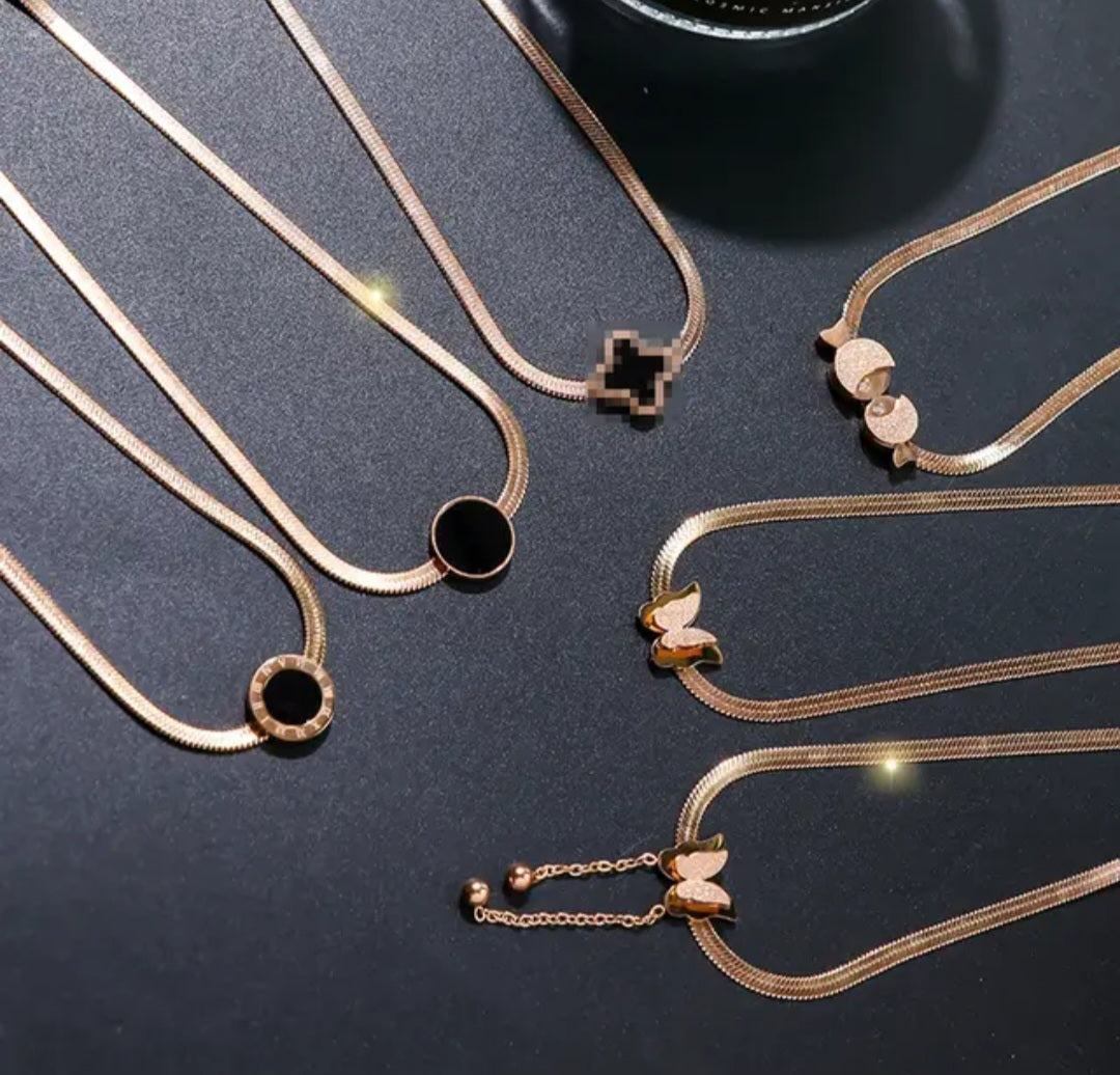 NIDA charm necklace showcasing intricate pendant designs in elegant gold tones, ideal for layering or wearing alone.